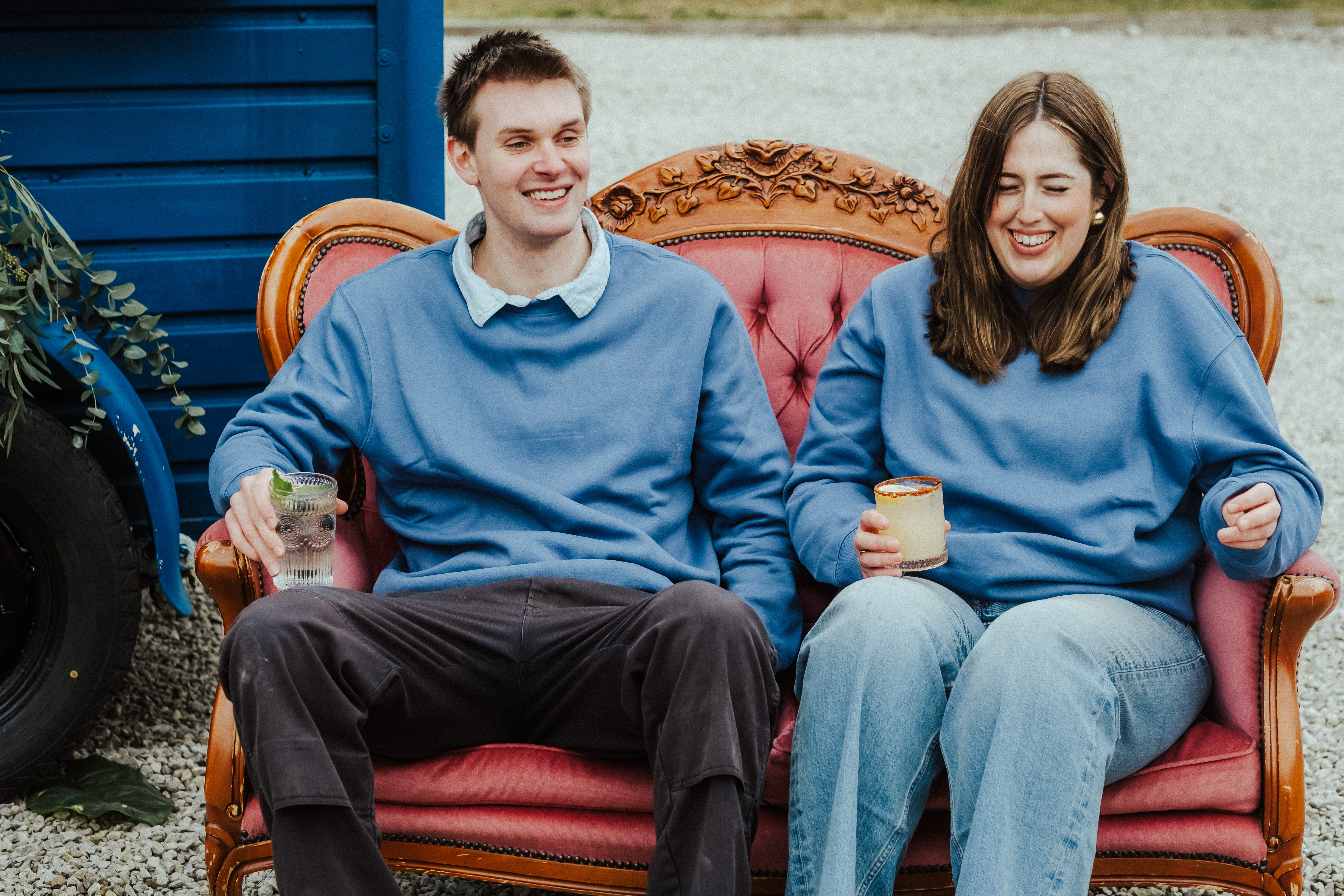 Liv and Fred enjoying a moment talking all things cocktails sat next to the Vintage Tipsy Horse Box at the Cherry Barn